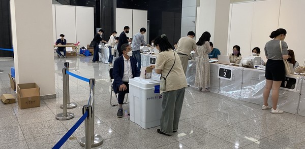 제8회 전국동시지방선거 사전투표 첫날인 27일 오후 광주 북구 전남대학교 컨벤션홀에 마련된 사전투표소에서 유권자들이 투표를 하기 위해 신분 확인을 하고 있다.