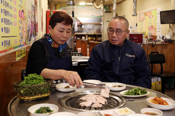나란히 앉아 막창을 구우며 대화하는 김창규 전 해태 타이거즈 응원단장 부부.
