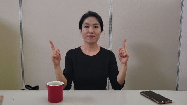 '만나다'를 뜻하는 수어를 하고 있는 김지영 수어 통역사.