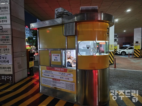 지난 14일 광주 상무지구의 L 오피스텔 주차요금 정산소에서 일하고 있는 박나원(54) 씨가  주차부스 안에서 바이올린을 켜고 있다.